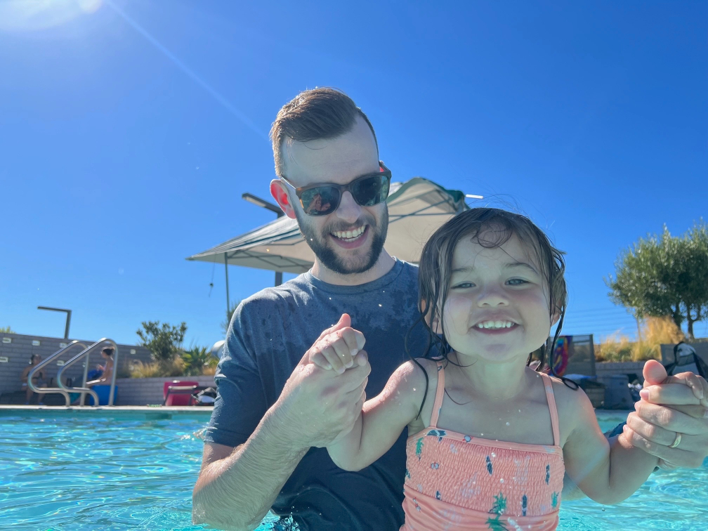 Dr. Courtin with his daughter in the pool