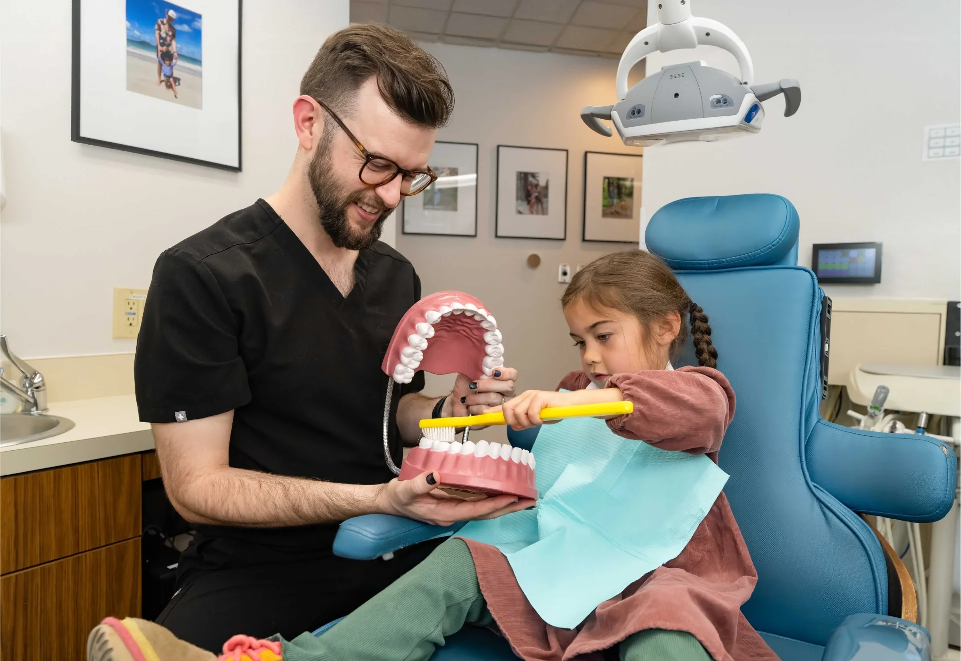 Dentist educating a young patient about oral health